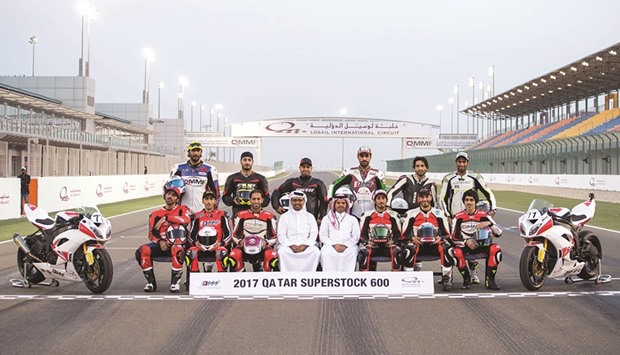 Qatar superstock riders pose with QMMF President Abdulrahman al-Mannai and  LCSC Vice President and General Manager Khalid al-Remaihi before the race yesterday.