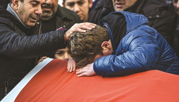 Relatives of Ayhan Arik, one of the victims of the Reina nightclub attack mourn during his funeral ceremony yesterday in Istanbul. Thirty-nine people, including many foreigners, were killed when a gunman went on a rampage at the nightclub where revellers were celebrating the New Year.