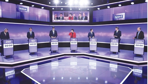 French politicians (from left) Francois de Rugy, Manuel Valls, Arnaud Montebourg, Sylvia Pinel, Benoit Hamon, Vincent Peillon, and Jean-Luc Bennahmias attend the final prime-time televised debate for the French leftu2019s presidential primaries in Paris, late on Thursday.