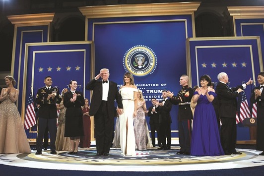 US President Donald Trump salutes while visiting the Armed Services Ball with first lady Melania Trump, Vice President Mike Pence and Karen Pence yesterday in Washington, DC. The stakes are high for companies that have prospered during the era of globalisation, locating factories where labouru2019s cheap and finding suppliers that can offer components at the most competitive prices. Trump has criticised the arrangements that make those integrated operations possible, calling the North American Free Trade Agreement u2013 which has allowed automakers like Ford Motor Co to build supply chains spanning the length of the continent u2013 a u201cdisaster.u201d