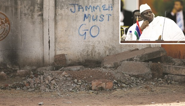 (TOP RIGHT INSERT) Jammeh: I have decided today in good conscience to relinquish the mantle of leadership of this great nation.  WRITING ON THE WALL: A wall with the words u2018Jammeh Must Gou2019 is seen along a street in Banjul.
