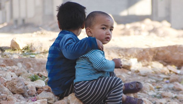 Children of war in Syriau2019s Aleppo rest on the ruins of the city.