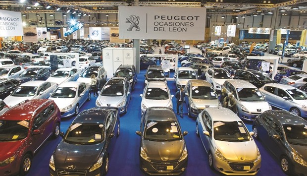 Visitors look at a collection of automobiles manufactured by PSA Peugeot Citroen kept on display during a second-hand vehicle show in Madrid (file). One reason for the build-up of fumes is the increased age of Spainu2019s car fleet as owners stopped replacing vehicles during the countryu2019s economic slump from 2009 to 2013.