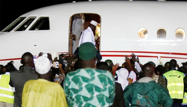Former Gambian President Yahya Jammeh boards a plane at the airport as he flying into exile from Gambia