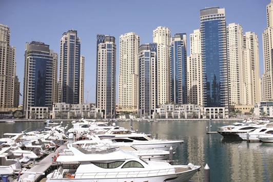 Residential skyscrapers overlooking luxury motor vessels in the harbour at Dubai Marina in Dubai. Residential values in Dubai have been declining since the second quarter of 2014 as weak job growth and ballooning supply drives values and rents lower.