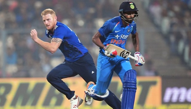 India's Hardik Pandya (R) runs to complete a run as England's Ben Stokes fields the ball