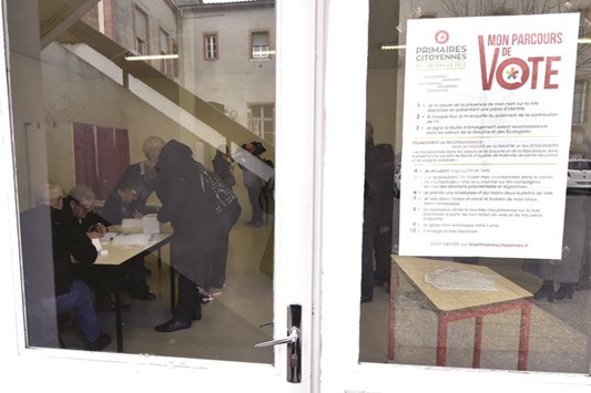 Instructions for voters are attached to the door of a polling station in Castelsarrasin, southern France, during the first round of the left-wing primary for the 2017 French presidential election.