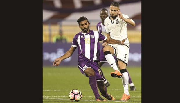 Al Saddu2019s Hamroun Jugurtha (right) vies for the ball with Muaitheru2019s Shahin Ali during their Qatar Stars League match at Al Gharafa Stadium yesterday. PICTURE: Anas Khalid