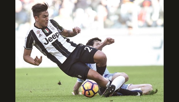 Juventusu2019 Paulo Dybala (left) and Laziou2019s Marco Parolo vie for the ball during the Italian Serie A match at the Juventus stadium in Turin, Italy. (Reuters)