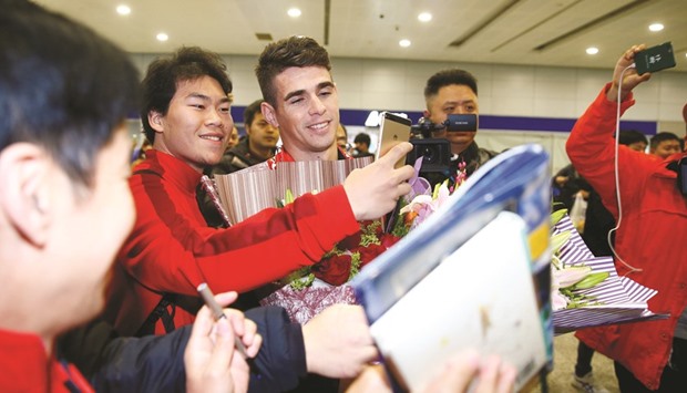 Brazilian midfielder Oscar arrives at the Shanghai Pudong International Airport yesterday, after agreeing to join China Super League club Shanghai SIPG. (Reuters)