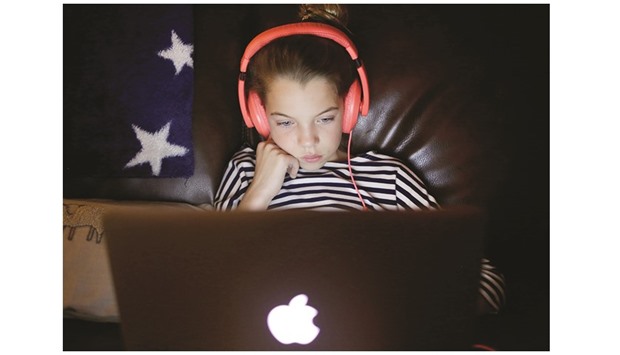 ON A SHORT LEASH: Ani Miller-Martinez, 10, watches a video during her 15 minutes of computer time at her home in San Jose, California. A recent survey of 1,800 parents, by San Francisco-based Common Sense Media, found that parents of teens and u2018tweens spent more than nine hours a day on screen media, including seven hours 43 minutes for personal use. Thatu2019s nearly every waking minute outside a normal work day u2013 although multitasking like checking Instagram while watching TV racked up double minutes.