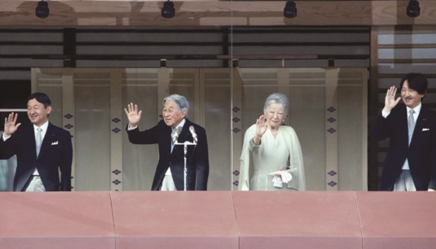 Japanese Emperor Akihito (second left) and Empress Michiko wave to well-wishers along with Crown Prince Naruhito (left)  and Prince Akishino during a public appearance for New Year celebrations at the Imperial Palace in Tokyo, Japan.