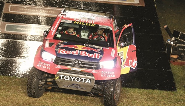 Nasser al-Attiyah and co-pilot Matthieu Baumel drive their Toyota during the symbolic start of the Dakar Rally yesterday.