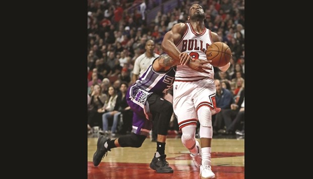 Dwyane Wade (R) of the Chicago Bulls is fouled by Matt Barnes of the Sacramento Kings at the United Center.
