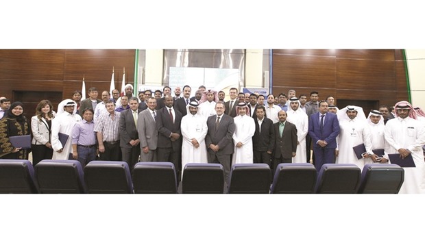 Oryx GTL employees who completed 10 years of service are seen with officials after the award ceremony.