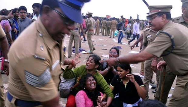 Police remove demonstrators from Marina Beach during a protest demanding a permanent solution to ensure the unhindered conduct of Jallikattu, a traditional bull-taming contest, in Chennai, on Monday.