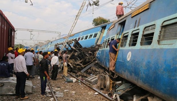 Rescue workers search for survivors after a passenger train derailed near Kuneru village in Vizianagaram district, in the southern state of Andhra Pradesh, on Sunday.