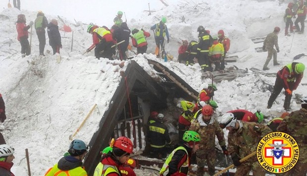 Rescue workers search around the Hotel Rigopiano in Farindola, central Italy, hit by an avalanche, in this undated picture released on January 22, 2017 provided by Alpine and Speleological Rescue Team.