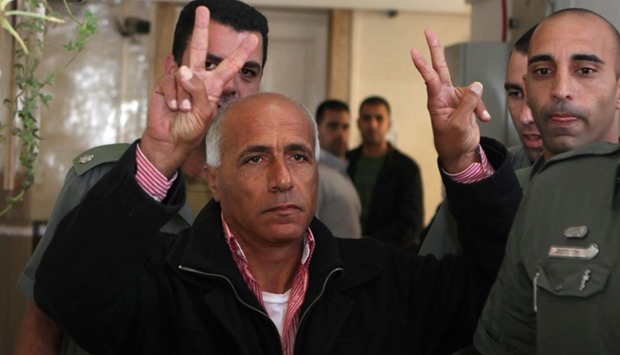 This file photo taken on December 29, 2009 shows Israel's nuclear whistle blower Mordechai Vanunu making the u201cVu201d for victory sign as he arrives at a Jerusalem court.