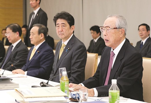 Chairman of a government advisory panel to discussions on emperor abdication Takashi Imai (right) speaks at a meeting at the PMu2019s official residence while Prime Minister Shinzo Abe (centre) looks on in Tokyo.