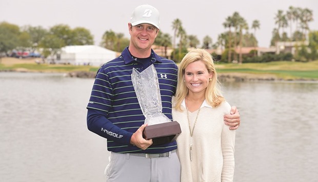Hudson Swafford poses with his trophy with wife Katherine Wainwright Brandon after winning the CareerBuilder Challenge in La Quinta, California, on Sunday. (AFP)