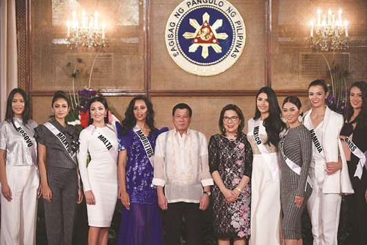 Miss Universe contestants pose for photos with Philippine President Rodrigo Duterte and Philippine Tourism Secretary Wanda Corazon Teo (fifth right) during a courtesy call at Malacanang Palace in Manila yesterday.