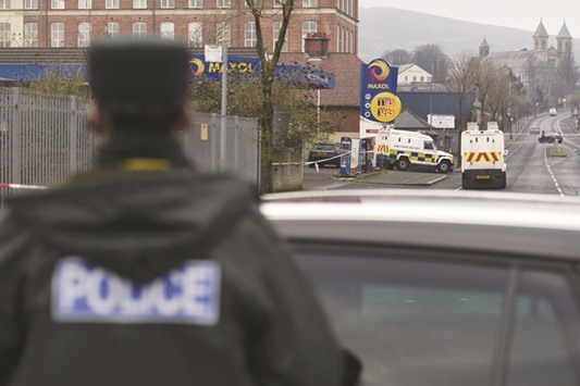 Police at the scene where a uniformed police officer was shot on the Crumlin Road in Belfast.
