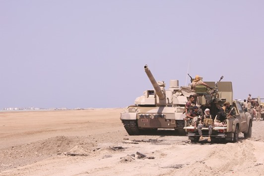 Members of the Yemeni army ride on the back of a military truck near the Red Sea coast city of Al-Mokha, Yemen yesterday.
