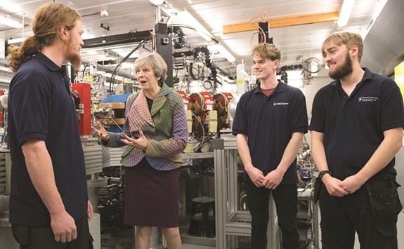 Prime Minister Theresa May meets technicians during a visit to Ski-Tech Daresbury in Warrington, north west England.