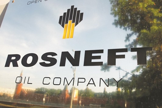 The logo of Rosneft is seen on a plaque outside the companyu2019s headquarters in Moscow. Russiau2019s government has sold a 19.5% stake in Rosneft to Glencore, a commodities producer and trader, and Qataru2019s sovereign wealth fund for 710.8bn roubles (about $11bn), helping to plug the widest budget deficit in six years following the slump in oil prices.