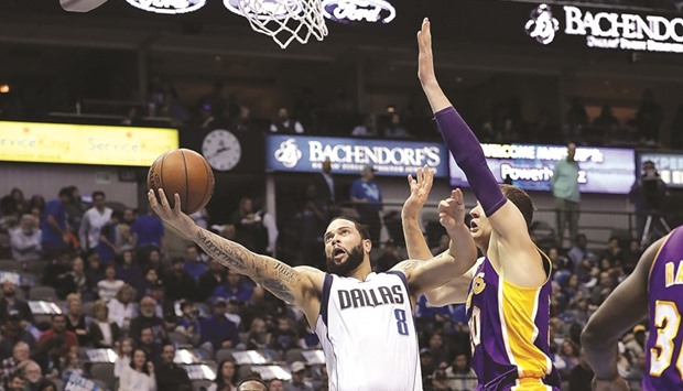 Deron Williams of the Dallas Mavericks takes a shot against Timofey Mozgov (right) of the Los Angeles Lakers during their NBA game at American Airlines Centre in Dallas, Texas, on Sunday. (AFP)