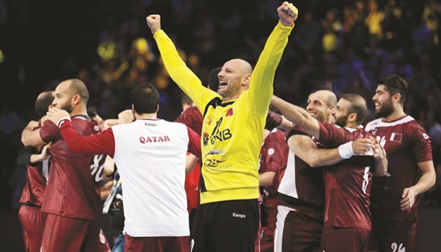 Qatar goalkeeper Danijel Saric celebrates with teammates after Sunday's stunning victory over European champions Germany in the World Handball Championship in Paris. (AFP)