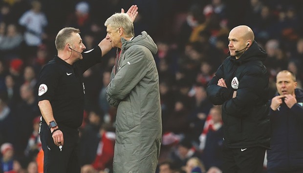 Arsenal manager Arsene Wenger (centre) is sent to the stands by referee Jonathan Moss (left) as fourth official Anthony Taylor looks on during the Gunners Premier League match against Burnley at the Emirates Stadium in London on Sunday. (AFP)