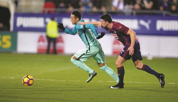 Barcelonau2019s Neymar (left) attempts to get past Eibaru2019s Ander Capa during the Spanish La Liga match on Sunday night. (Reuters)