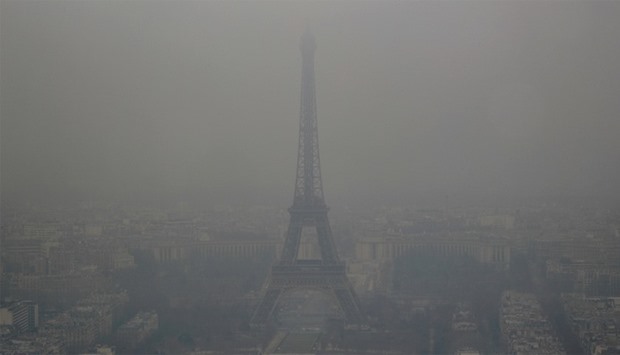 The Eiffel Tower is seen in the fog 