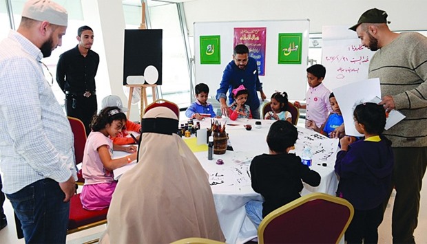 Children participate in an Arabic calligraphy workshop at the event