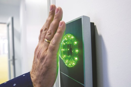 An employee scans the palm on an access identity scanner inside FinTech Groupu2019s in Frankfurt. Fintech could help Islamic banks become more efficient and scale up their operations, according to the central bank of Malaysia, which said last year it was reviewing regulations to address fintech firms.