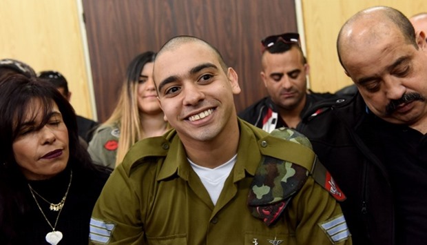 Israeli soldier Elor Azaria, who was convicted of manslaughter for shooting dead a prone and wounded Palestinian assailant, in a case that has deeply divided Israel, sits with his parents as he waits for his sentence hearing at the military court in Tel Aviv.