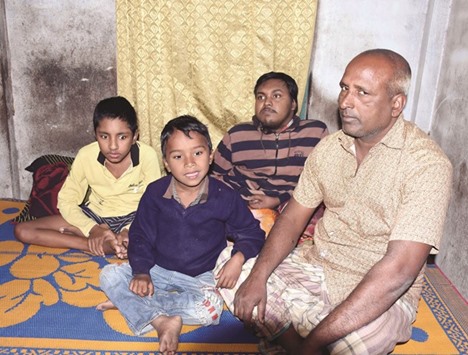 Tofazzal Hossain, right, who has sparked a debate over assisted suicide, is seen with his two sons and grandson (second left) in Meherpur.