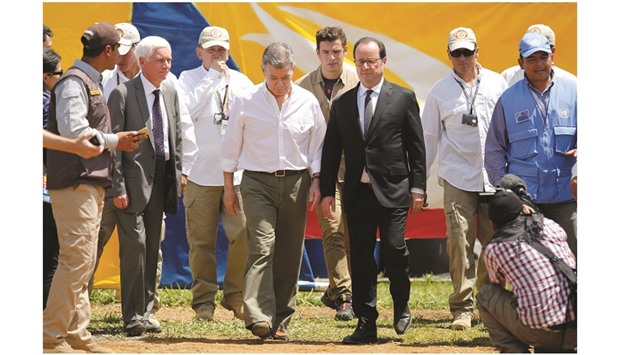French President Francoise Hollande and his Colombian counterpart Juan Manuel Santos visit the Farc concentration zone of Caldono, Colombia, yesterday.