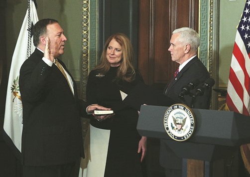 Mike Pompeo (left) is sworn in as CIA Director by Vice President Mike Pence as his wife Susan Pompeo looks on at Eisenhower Executive Office Building in Washington, DC on Monday after Pompeo was confirmed for the position by the Senate.