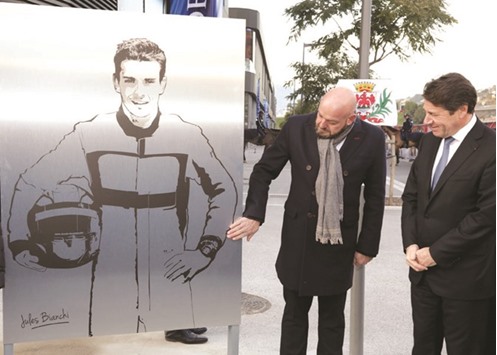 Philippe Bianchi (left), the father of Jules Bianchi, poses with Christian Estrosi, President of the Provence Alpes Cote du2019Azur (PACA) region, near a plaque with the drawing of his son during its unveiling in Nice, France on Monday. Bianchi died on July 17, 2015 after an accident during the Japanese GP. (Reuters)