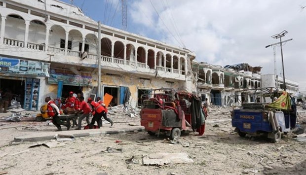 Rescuers carry an unidentified injured man from the scene of an explosion in front of Dayah Hotel in Mogadishu on Wednesday.