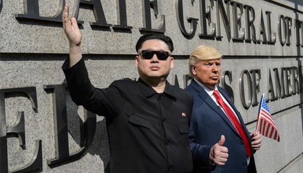 North Korean leader Kim Jong-Un, impersonated by Hong Kong actor Howard (left), and US President Donald Trump, impersonated by US actor Dennis, pose outside the US consulate in Hong Kong on Wednesday.