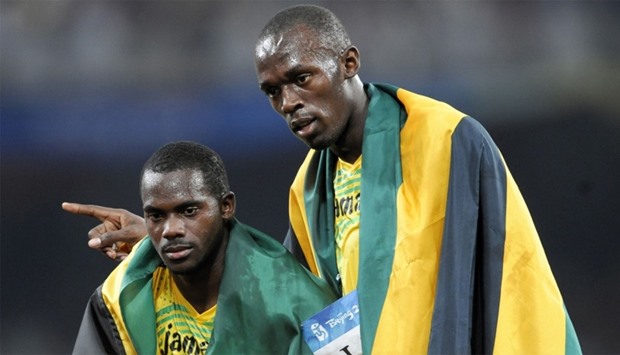 Jamaica's Nesta Carter (L) and Usain Bolt celebrating after winning the men's 4u00d7100m relay final