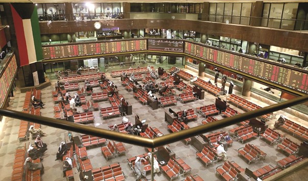Traders follow shares at the the Kuwait Stock Exchange (KSE) in Kuwait City.  Kuwaitu2019s index, which has surged more than 19% this month, gained 0.5%  yesterday in heavy trade, although decliners outnumbered advancers by  55 to 53.
