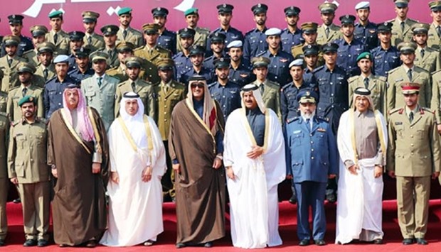 HH the Emir Sheikh Tamim bin Hamad al-Thani poses for a group photo at the graduation ceremony of the 12th class of officer cadets from the Ahmed bin Mohamed Military College.