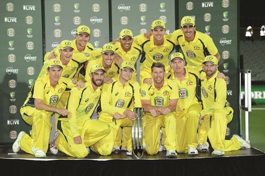 The Australian team pose with the trophy after winning the one-day international series against Pakistan at the Adelaide Oval yesterday. (AFP)
