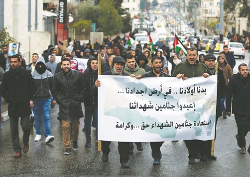 Palestinian protesters hold a banner reading in Arabic u2018We want our children in the land of our ancestors, return the bodies of our martyrs, it is right and dignityu2019 during a demonstration yesterday in the West Bank town of Bethlehem, demanding that Israeli authorities return the bodies of Palestinians killed during attacks on Israel.