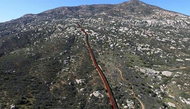 Aerial picture taken with a drone shows the border fencing between the US and Mexico in Tecate, northwestern Mexico.